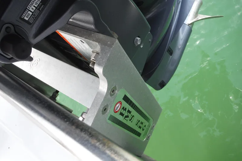 Slide: The Image of Outboard motor mount on 1999 Intrepid 289 Center Console boat, near green water. - 48