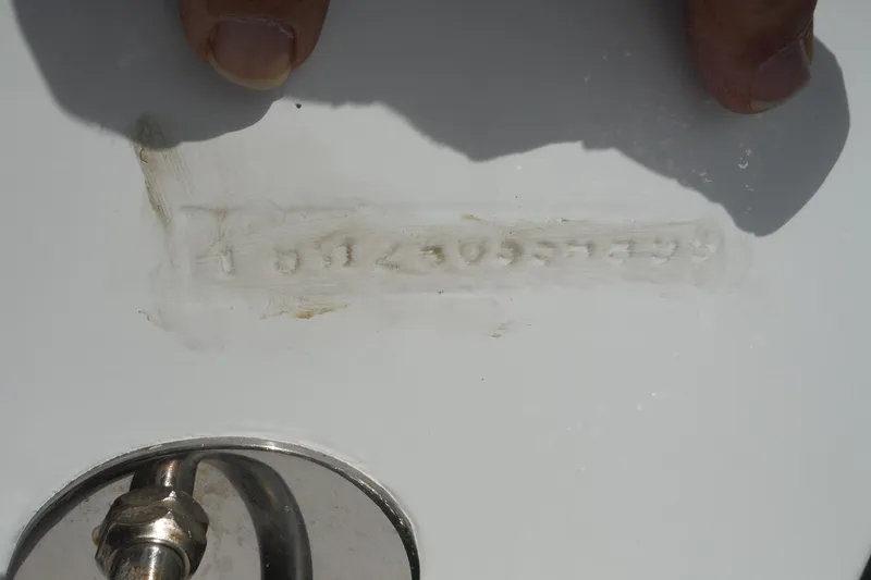 Slide: The Image of Close-up of a 1999 Intrepid 289 Center Console hull identification number. - 52