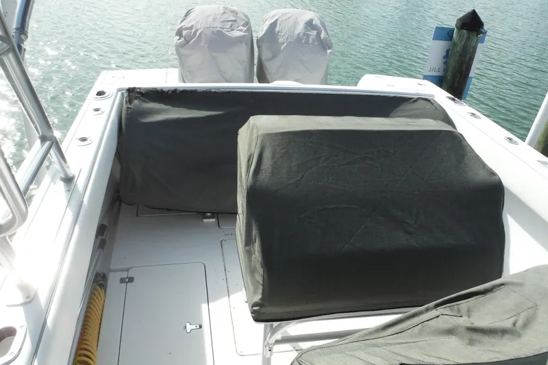 Slide: The Image of 1999 Intrepid 289 Center Console boat with covered seating and engines. - 54
