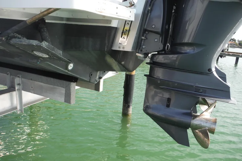 Slide: The Image of 1999 Intrepid 289 Center Console boat engine and propeller above water. - 55