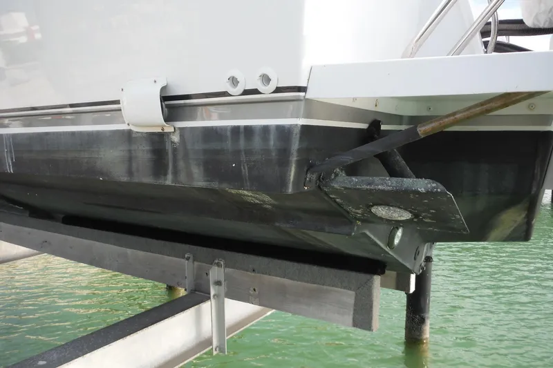 Slide: The Image of 1999 Intrepid 289 Center Console boat hull on lift, showing trim tab and waterline. - 56