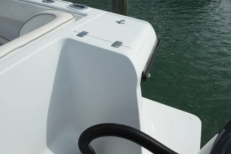 Slide: The Image of 1999 Intrepid 289 Center Console boat detail with white seating and water backdrop. - 8