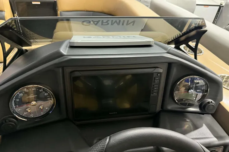 Slide: The Image of 2026 Manitou Encore VP 230 dashboard with Garmin navigation system and gauges. - 11