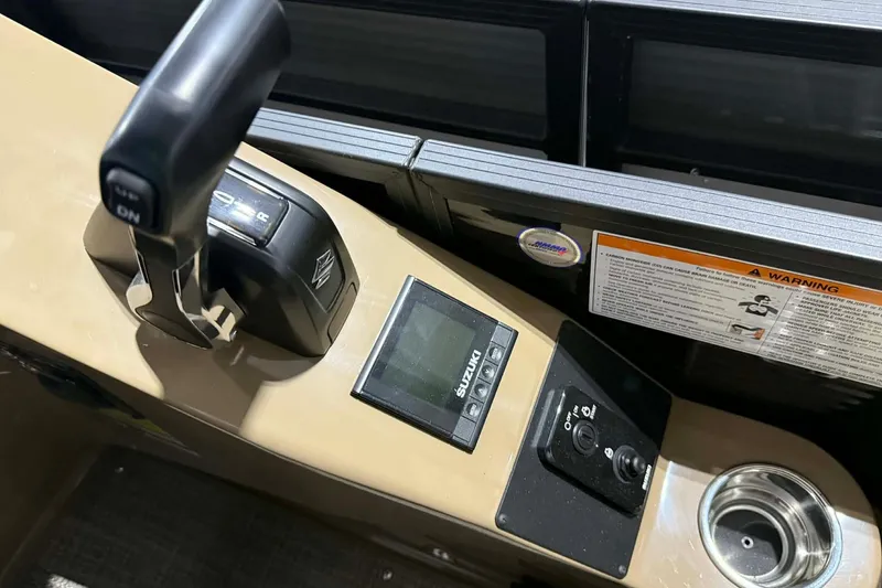 Slide: The Image of Control panel of 2026 Manitou Encore VP 230 boat with throttle and display. - 14