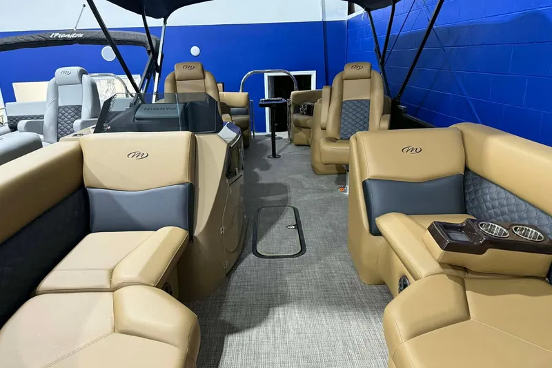 Slide: The Image of 2026 Manitou Encore VP 230 pontoon boat interior with tan and gray seating. - 3