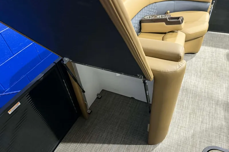 Slide: The Image of 2026 Manitou Encore VP 230 interior with tan seating and cup holders. - 6