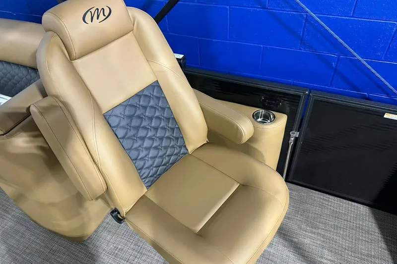 Slide: The Image of Luxurious tan seat of 2026 Manitou Encore VP 230 with cup holder and quilted design. - 8
