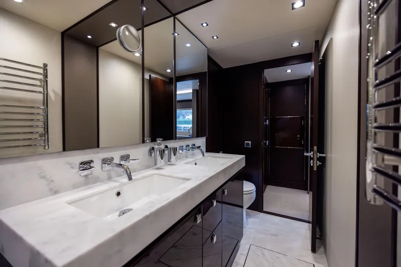 Slide: The Image of Luxurious bathroom interior on a 2019 Sunseeker 76 yacht, featuring dual sinks and modern fixtures. - 112