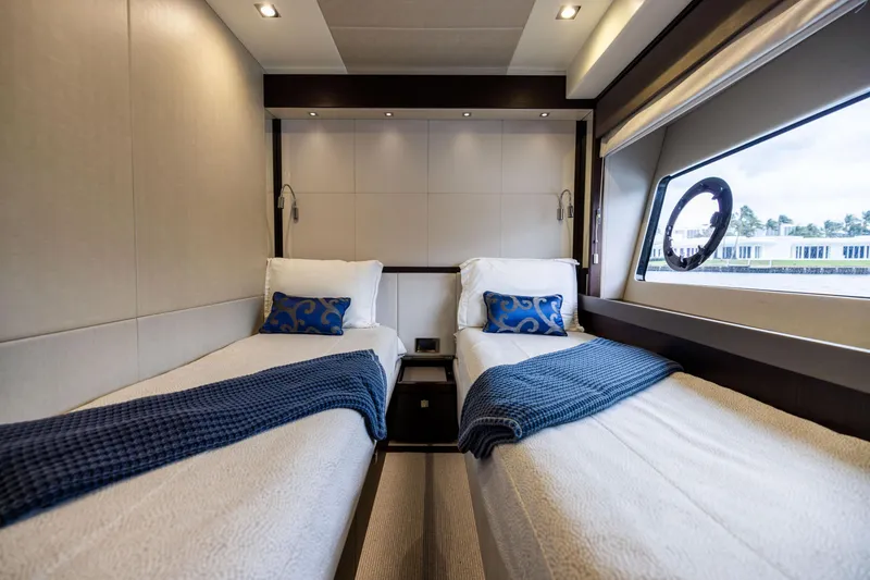 Slide: The Image of Luxurious twin cabin interior on 2019 Sunseeker 76 yacht with elegant bedding and window view. - 120