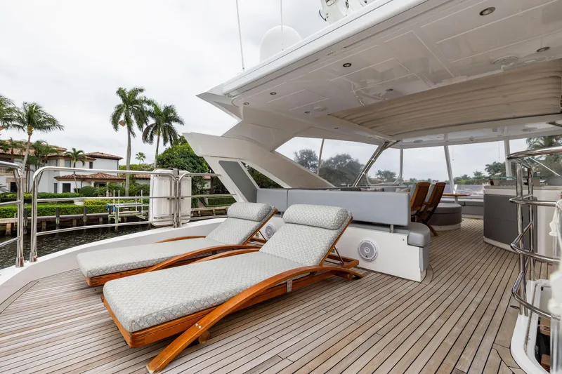 Slide: The Image of Luxurious 2019 Sunseeker 76 yacht deck with sun loungers and elegant seating area. - 4