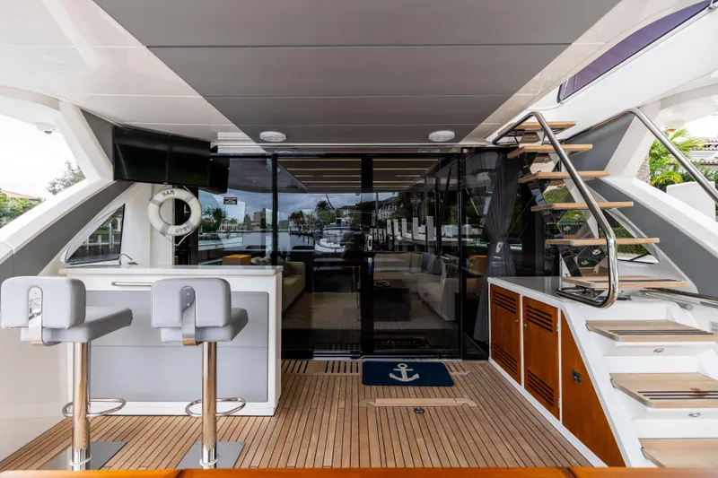 Slide: The Image of Luxurious 2019 Sunseeker 76 yacht interior with bar, seating, and modern staircase. - 43