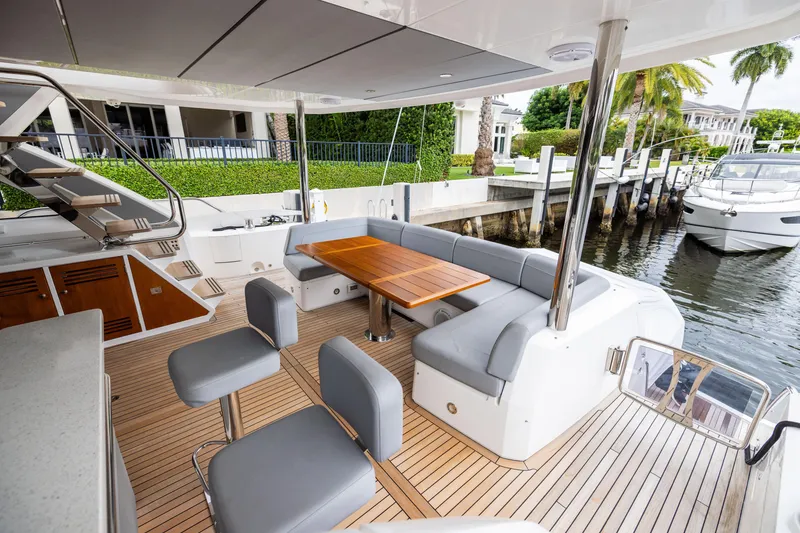 Slide: The Image of Luxurious 2019 Sunseeker 76 yacht deck with elegant seating and wooden table. - 47