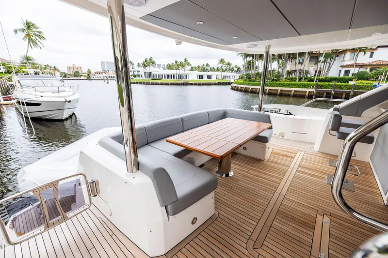 Slide: The Image of Luxurious 2019 Sunseeker 76 yacht deck with elegant seating and waterfront view. - 49