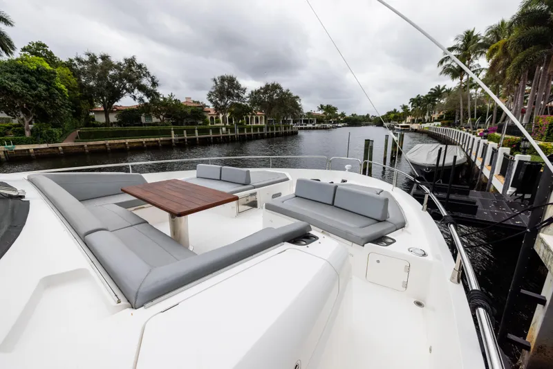 Slide: The Image of Luxurious 2019 Sunseeker 76 yacht with spacious deck seating and scenic canal view. - 53