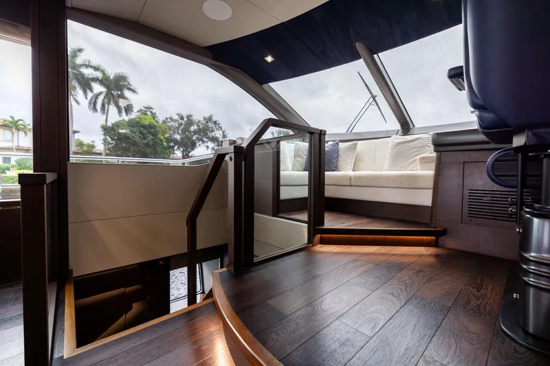 Slide: The Image of Luxurious interior of 2019 Sunseeker 76 yacht with elegant wood flooring and plush seating. - 82