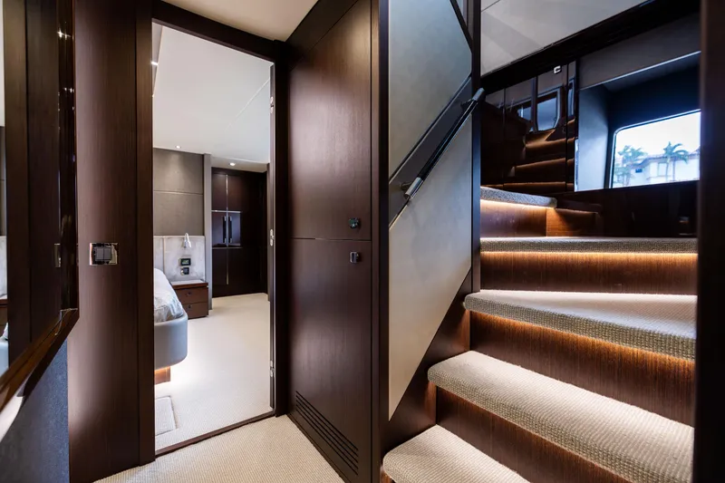 Slide: The Image of Luxurious interior of 2019 Sunseeker 76 yacht, featuring elegant staircase and modern bedroom. - 95