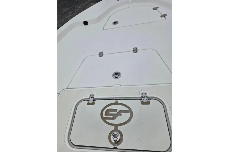 Slide: The Image of 2016 Sea Fox 22XTR Viper boat deck with storage compartments and logo. - 18