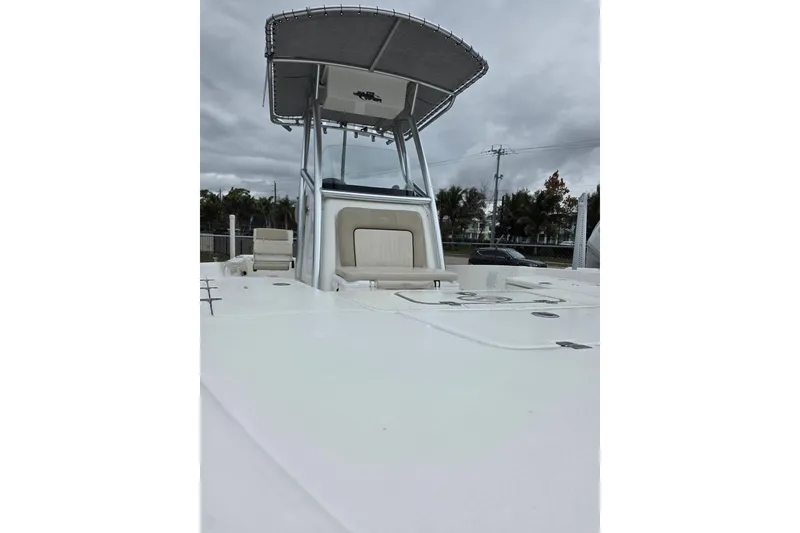 Slide: The Image of 2016 Sea Fox 22XTR Viper boat with T-top and seating, parked outdoors. - 9