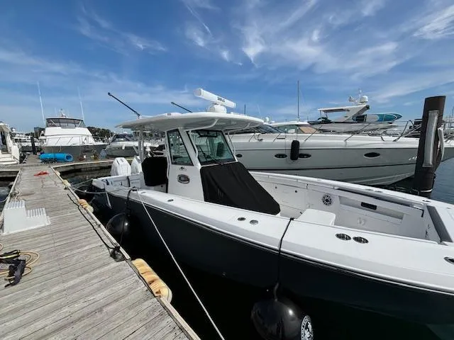 Slide: The Image of 2025 Crevalle 33 CTF boat docked at marina under clear blue sky. - 16