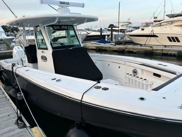 Slide: The Image of 2025 Crevalle 33 CTF boat docked at marina, featuring sleek design and modern equipment. - 18
