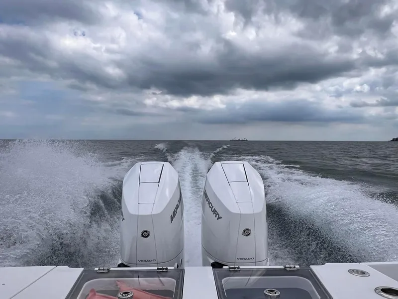 Slide: The Image of Crevalle 33 CTF 2025 boat with twin Mercury engines on open water. - 5