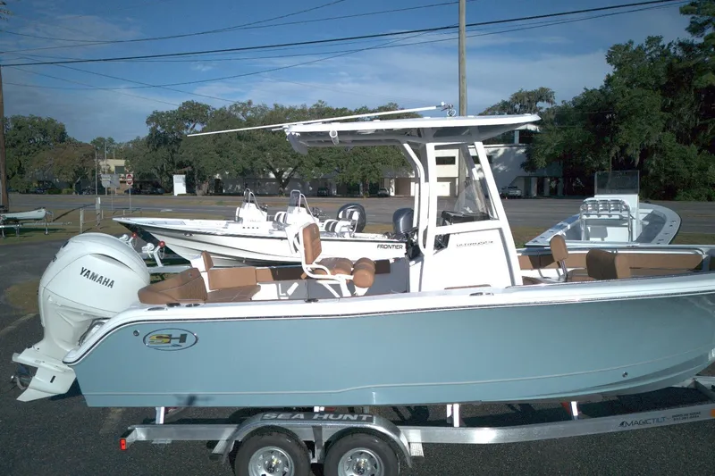 Slide: The Image of 2026 Sea Hunt Ultra 229 boat with Yamaha engine on trailer, parked outdoors. - 11