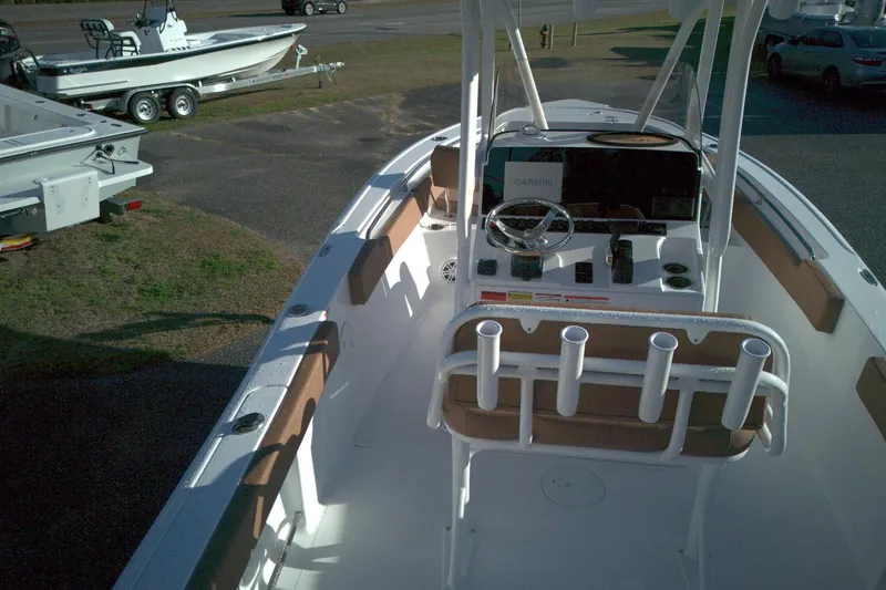 Slide: The Image of 2026 Sea Hunt Ultra 229 boat interior with console and rod holders. - 2