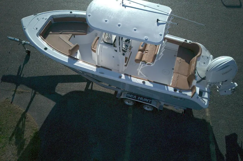 Slide: The Image of Aerial view of 2026 Sea Hunt Ultra 229 boat on trailer, featuring spacious seating and Yamaha engine. - 3
