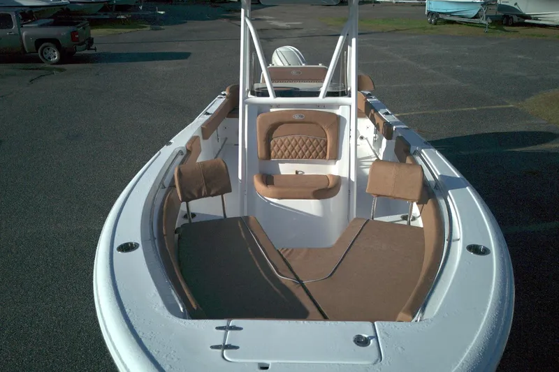 Slide: The Image of 2026 Sea Hunt Ultra 229 boat with brown seating and spacious deck. - 9