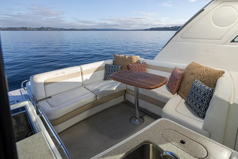 Slide: The Image of Luxurious 2010 Sea Ray Sundancer yacht interior with cushioned seating and scenic water view. - 12