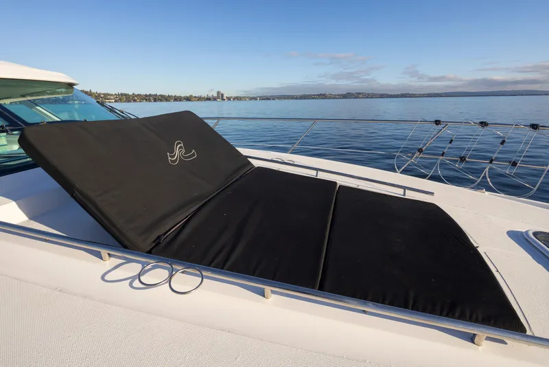 Slide: The Image of 2010 Sea Ray Sundancer yacht with sunpad on deck, overlooking calm waters. - 17