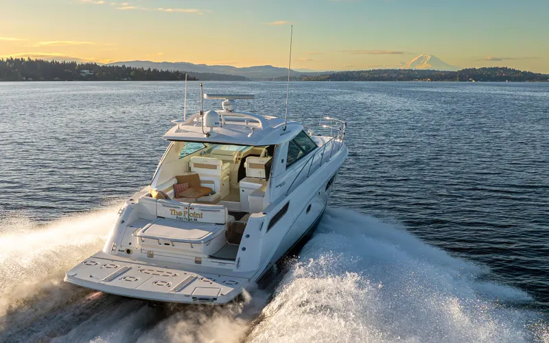 Slide: The Image of 2010 Sea Ray Sundancer yacht cruising on a scenic lake at sunset. - 19