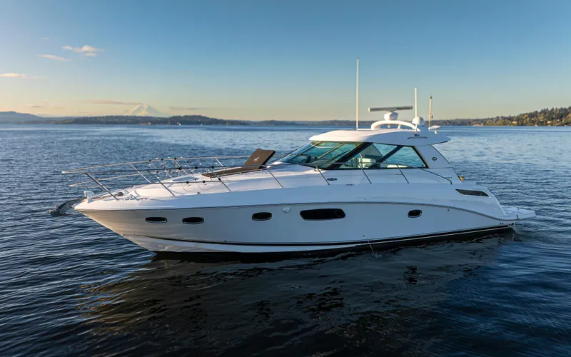 Slide: The Image of 2010 Sea Ray Sundancer yacht on calm water under clear blue sky. - 2