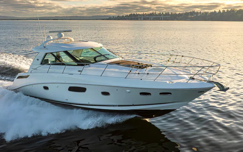 Slide: The Image of 2010 Sea Ray Sundancer yacht cruising on calm waters at sunset. - 24