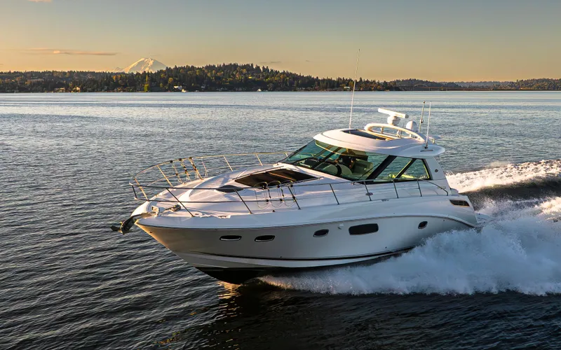 Slide: The Image of 2010 Sea Ray Sundancer cruising on a scenic lake with mountain backdrop. - 28