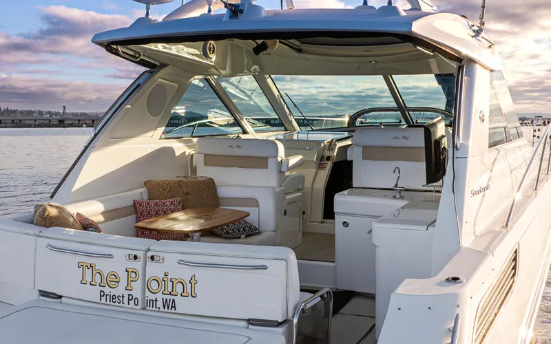 Slide: The Image of 2010 Sea Ray Sundancer yacht docked, featuring a luxurious open deck and seating area. - 4