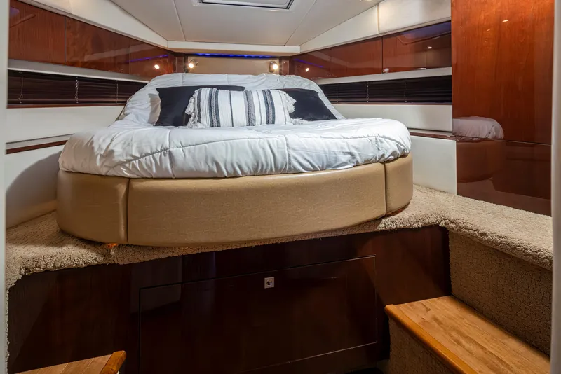 Slide: The Image of Luxurious 2010 Sea Ray Sundancer cabin interior with cozy bed and elegant wood finishes. - 40