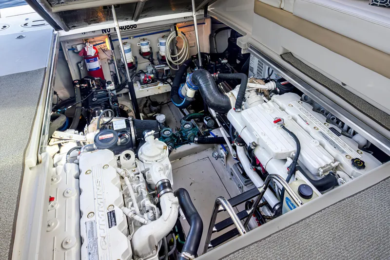 Slide: The Image of Engine room of a 2010 Sea Ray Sundancer boat, featuring Cummins engines and equipment. - 47
