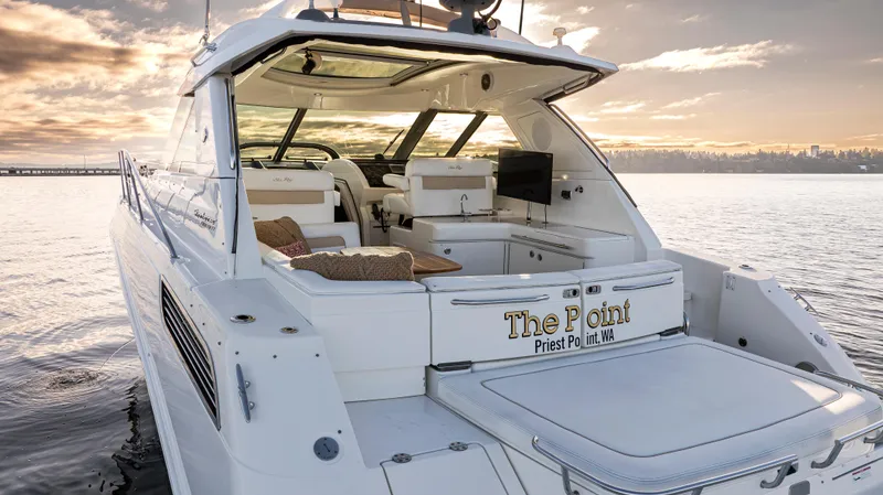 Slide: The Image of Luxury 2010 Sea Ray Sundancer yacht on serene water at sunset. - 5