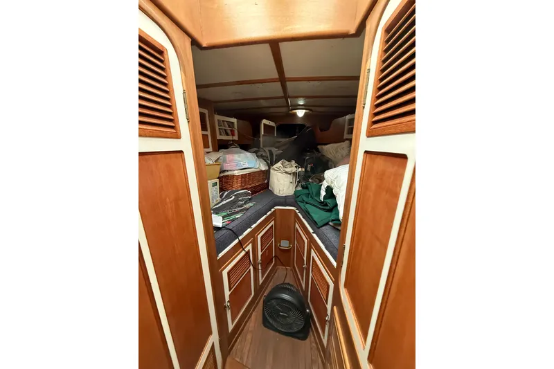 Slide: The Image of Interior of a 1990 Custom 46 boat with wooden cabinetry and storage space. - 14