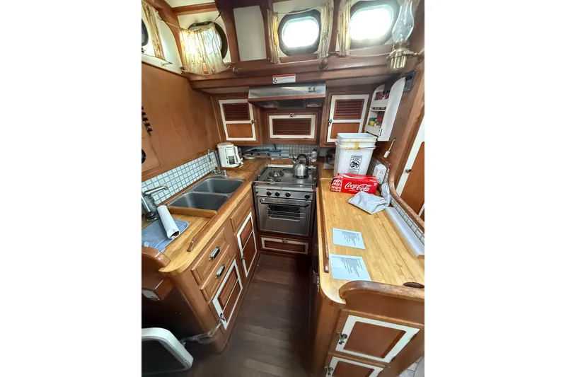 Slide: The Image of Cozy wooden boat kitchen with stove, sink, and storage, Custom model 46, 1990. - 18