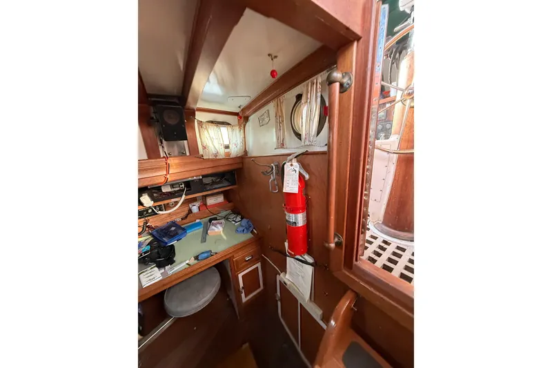 Slide: The Image of Interior of a 1990 Custom 46 boat with a workspace and fire extinguisher. - 21