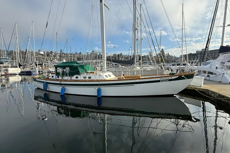 Slide: The Image of Sailboat docked in marina, HMMD 46 model, 1990, with clear sky reflection. - 4