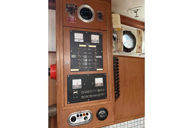 Slide: The Image of Control panel of a 1990 HMMD 46 boat with gauges and switches. - 9
