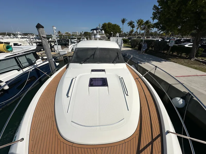 Slide: The Image of 2018 Bavaria S40 Coupe yacht docked at a marina with wooden deck and sleek design. - 16