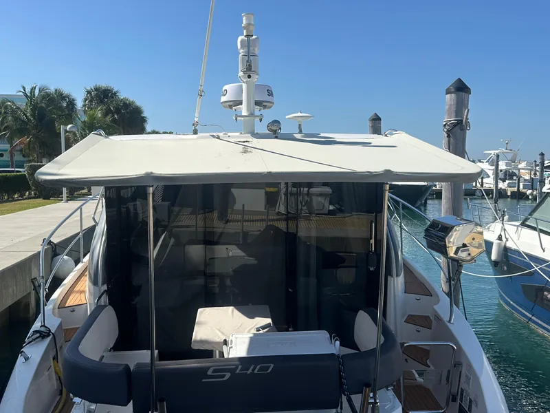 Slide: The Image of 2018 Bavaria S40 Coupe docked at marina, featuring spacious deck and canopy. - 29