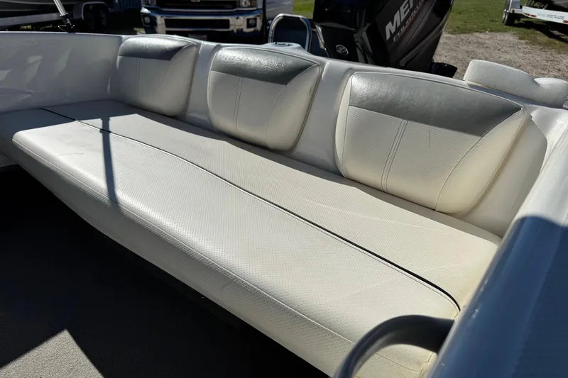 Slide: The Image of 2013 Bayliner 160 Bowrider interior with white cushioned seating. - 3