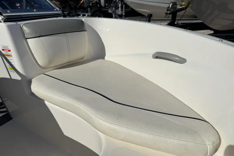 Slide: The Image of 2013 Bayliner 160 Bowrider interior with white cushioned seating and sleek design. - 5