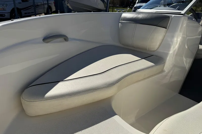 Slide: The Image of 2013 Bayliner 160 Bowrider interior seating with white upholstery and sleek design. - 6