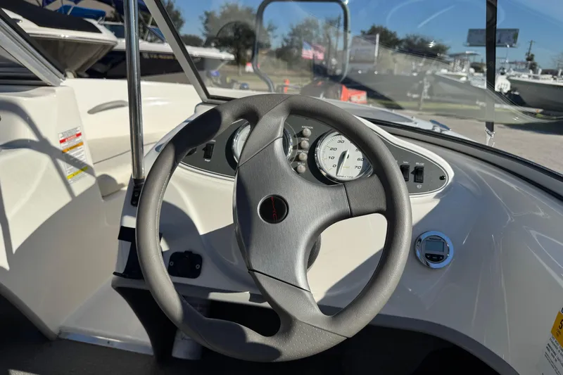 Slide: The Image of Steering wheel and dashboard of a 2013 Bayliner 160 Bowrider boat. - 7